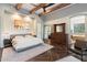 Main bedroom with wood beam ceiling, fireplace and large windows at 6708 E Calle De Las Estrellas Rd, Cave Creek, AZ 85331