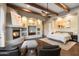 Bright main bedroom with wood beams, built-ins and fireplace at 6708 E Calle De Las Estrellas Rd, Cave Creek, AZ 85331