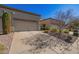 Front view of charming home with two-car garage and well-manicured landscaping at 6730 E Hermosa Vista Dr # 75, Mesa, AZ 85215