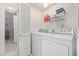 Bright laundry room with washer, dryer, and storage shelves at 6730 E Hermosa Vista Dr # 75, Mesa, AZ 85215