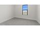 Simple bedroom with grey carpet and a large window at 699 E Greenback Dr, San Tan Valley, AZ 85140