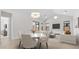 Bright dining area with modern table and chairs, adjacent to living room at 699 E Greenback Dr, San Tan Valley, AZ 85140