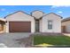 One-story home with brown garage door and landscaped lawn at 699 E Greenback Dr, San Tan Valley, AZ 85140