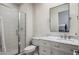 Bathroom with marble vanity, glass shower, and white toilet at 7040 N 1St Ave, Phoenix, AZ 85021