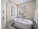 Relaxing bathroom with freestanding soaking tub and marble tile at 7040 N 1St Ave, Phoenix, AZ 85021