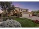 Beautiful two-story home with lush landscaping and a three-car garage at 7040 N 1St Ave, Phoenix, AZ 85021