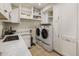 Laundry room with washer, dryer, and ample storage at 7040 N 1St Ave, Phoenix, AZ 85021