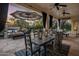 Covered patio with dining table, fire pit, and comfortable seating at 7040 N 1St Ave, Phoenix, AZ 85021