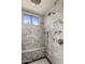 Spa-like shower with marble tile and built-in seat at 7040 N 1St Ave, Phoenix, AZ 85021