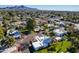 Aerial view of a community with houses, pool, and mountain backdrop at 8018 N 3Rd Pl, Phoenix, AZ 85020