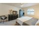 Bedroom with king-size bed, arched window, and dresser at 8018 N 3Rd Pl, Phoenix, AZ 85020