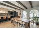 Dining area with long wooden table, kitchen, and exposed beams at 8018 N 3Rd Pl, Phoenix, AZ 85020