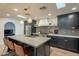 Modern kitchen with dark cabinetry, concrete island, and gold accents at 8018 N 3Rd Pl, Phoenix, AZ 85020