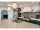 Modern kitchen with dark cabinets, herringbone backsplash, and gold fixtures at 8018 N 3Rd Pl, Phoenix, AZ 85020