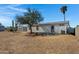 Large backyard with mature trees, desert landscaping and wood fence at 8155 E Baltimore St, Mesa, AZ 85207