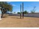 Large backyard with mature trees, desert landscaping, vinyl fence and electrical poles at 8155 E Baltimore St, Mesa, AZ 85207