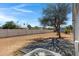 Large backyard with mature trees, desert landscaping, vinyl fence and a paved patio at 8155 E Baltimore St, Mesa, AZ 85207