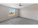 Well-lit bedroom featuring ceiling fan and window blinds at 8155 E Baltimore St, Mesa, AZ 85207