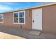 Front door and windows of a tan manufactured home at 8155 E Baltimore St, Mesa, AZ 85207