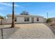 Charming single story home featuring a paved drive, neutral paint, desert landscaping and mature palm tree at 8155 E Baltimore St, Mesa, AZ 85207