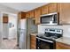 Modern kitchen featuring stainless steel appliances and wood cabinets at 8155 E Baltimore St, Mesa, AZ 85207