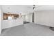 Living room, grey carpet, kitchen with granite counters at 8155 E Baltimore St, Mesa, AZ 85207