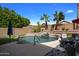 Inviting backyard with a sparkling pool, waterfall feature, and patio seating at 9036 E Halifax Cir, Mesa, AZ 85207