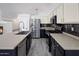 Modern kitchen with stainless steel appliances and dark cabinetry at 9036 E Halifax Cir, Mesa, AZ 85207