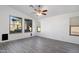 Living room featuring gray flooring, ceiling fan, and large windows at 9036 E Halifax Cir, Mesa, AZ 85207