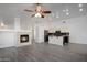 Spacious living room with fireplace and adjacent kitchen at 9036 E Halifax Cir, Mesa, AZ 85207