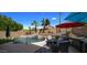 Relaxing pool area with multiple seating options and umbrellas at 9036 E Halifax Cir, Mesa, AZ 85207