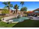 Large kidney shaped pool with waterfall feature at 9036 E Halifax Cir, Mesa, AZ 85207