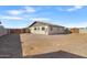 Backyard view, gravel ground, and partial fence at 9163 W Swansea Dr, Arizona City, AZ 85123