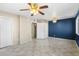 Large bedroom with tile floors and ceiling fan at 9163 W Swansea Dr, Arizona City, AZ 85123