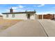 Front view of the house with driveway and fence at 9163 W Swansea Dr, Arizona City, AZ 85123