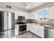 Galley kitchen with stainless steel appliances and white cabinets at 9163 W Swansea Dr, Arizona City, AZ 85123