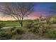 Scenic view of a lush green golf course at sunset at 9280 E Thompson Peak Pkwy # 15, Scottsdale, AZ 85255