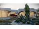 Curved modern home with desert landscaping and large windows at 9428 E Pinnacle Vista Dr, Scottsdale, AZ 85255