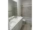 Bathroom with double vanity, bathtub, and marble-look tile at 9514 N 178Th Dr, Waddell, AZ 85355