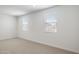 Well-lit bedroom featuring two windows with blinds at 9514 N 178Th Dr, Waddell, AZ 85355