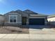 New single-story home with gray exterior, two-car garage, and desert landscaping at 9514 N 178Th Dr, Waddell, AZ 85355