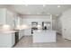 Modern kitchen with white cabinets, stainless steel appliances, and a large island at 9514 N 178Th Dr, Waddell, AZ 85355