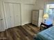 Bright bedroom with double closets and wood-look flooring at 9746 N 105Th Dr, Sun City, AZ 85351