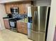 Stainless steel appliances and granite countertops highlight this kitchen at 9746 N 105Th Dr, Sun City, AZ 85351