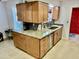 Well-equipped kitchen with granite countertops and wooden cabinets at 9746 N 105Th Dr, Sun City, AZ 85351