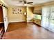 Bright room featuring hard wood flooring, a sliding glass door, and a barn door entry at 9746 N 105Th Dr, Sun City, AZ 85351