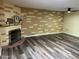 Inviting living room featuring new floors, a decorative wall, a fireplace, and a modern ceiling fan at 9746 N 105Th Dr, Sun City, AZ 85351