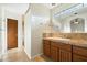 Bathroom with single vanity, granite countertop and decorative mirror at 9926 E Hidden Green Dr, Scottsdale, AZ 85262