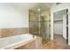 Bathroom featuring a glass shower, soaking tub, and walk-in closet at 9926 E Hidden Green Dr, Scottsdale, AZ 85262