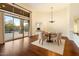 Elegant dining room with a chandelier, hardwood floors, and access to an outdoor living space at 9926 E Hidden Green Dr, Scottsdale, AZ 85262